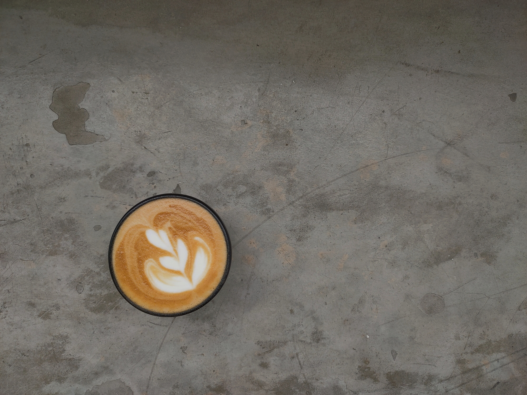 Coffee with Latte Art on Concrete Background